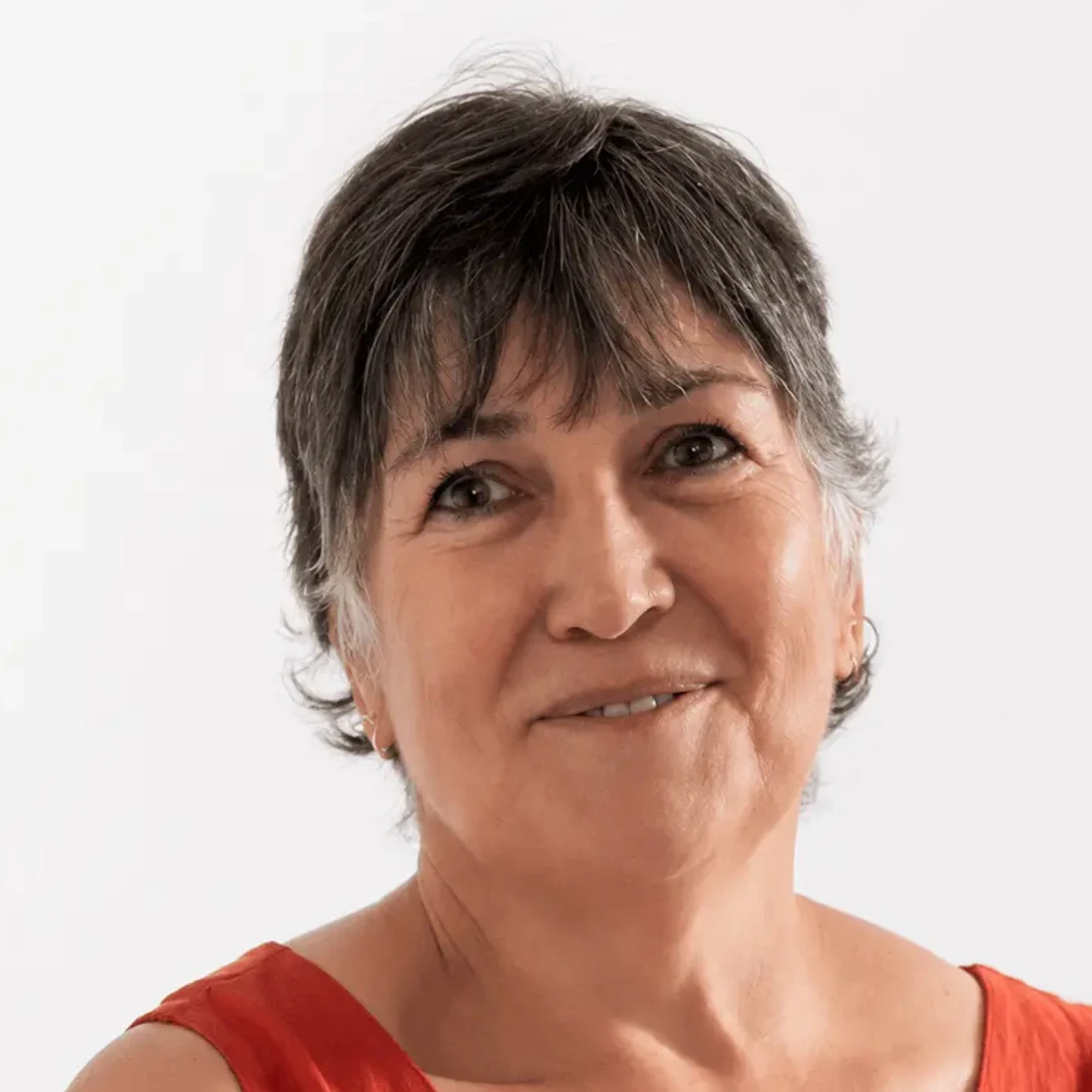 Dr Lisa de Rijk wearing a red sleeveless top against a white background.